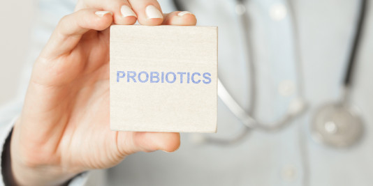 Closeup of physician holding a sign that reads “probiotics.”